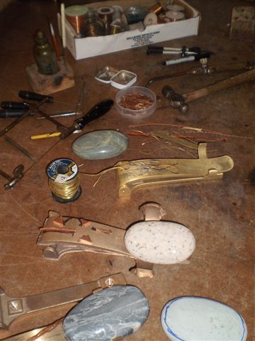 Door knockers being made on workbench